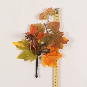 Detail of fall decoration branch with maple leaves and pumpkin measuring about 22cm