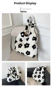 Close-up of white plush handbag featuring black floral patterns and soft faux fur texture
