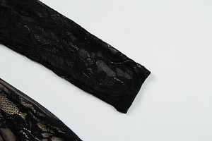 Macro shot of delicate floral black lace fabric showing intricate patterns and texture