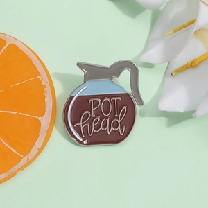 Enamel coffee pot pin with POT head lettering and floral decorative accessories
