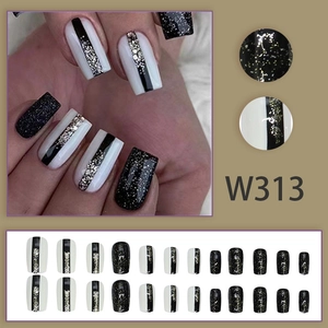 Long oval black and white press-on nails with silver glitter accent, 24-piece full set