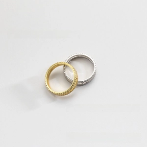 Close-up of dual stacked eternity rings with pave crystals in gold and silver finish