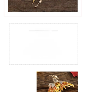 Detail of phoenix brooch with golden alloy, white rhinestones and orange enamel