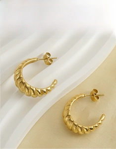 Detailed view of 18K gold plated stainless steel twisted croissant hoop earrings
