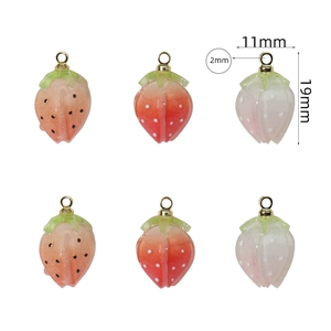 Detailed view of handmade strawberry pendants with 19mm x 11mm dimensions and gold loops