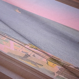 Detailed macro view showing the soft plush texture and artistic sunset print of the tapestry