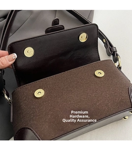 Detail of vintage shoulder bag featuring wool fabric texture and dual magnetic gold buckles