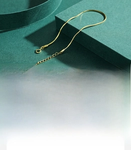 Detail showing gold S925 sterling silver snake chain with lobster clasp and drop pendant