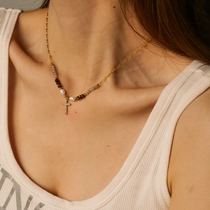 Gold titanium necklace with zircon cross pendant and freshwater pearl worn by model