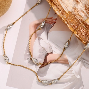 Detail of 18K gold plated double-layer beaded chain with irregular silver charms