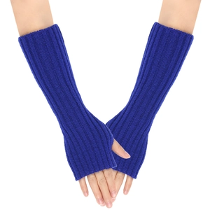 Detail of royal blue cable knit fingerless gloves with thumb hole and vertical ribbed texture