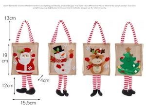 Set of four Christmas gift bags with Santa, snowman and reindeer cartoon designs