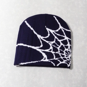 Close-up of knit texture and spider web jacquard pattern on the purple beanie