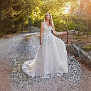 Elegant long A-line wedding dress with deep V-neck, floral lace bodice and tulle train