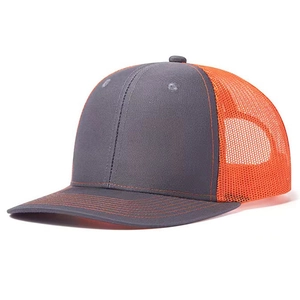 Side view of gray and orange mesh trucker hat with contrast stitching and breathable mesh