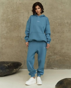 Detail of grey-blue fleece tracksuit with hoodie and matching high waist sweatpants