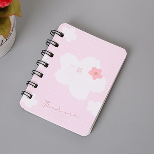 Macro detail of A7 pink sakura spiral notebook with black metal dual coil binding