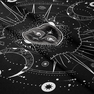 Detailed close-up of a black and white tapestry showing sun and moon phases