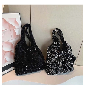 Detail view of large sequin tote bags in black and silver finishes for women