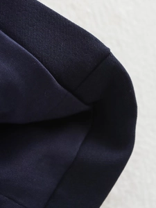 Vue macro de la texture du tissu bleu foncé et détails de couture sans couture du vêtement