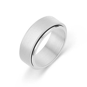 Macro view of silver spinner ring featuring brushed finish texture and polished edges