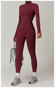 Detail of burgundy yoga jacket with thumbhole cuffs and a seamless stand collar