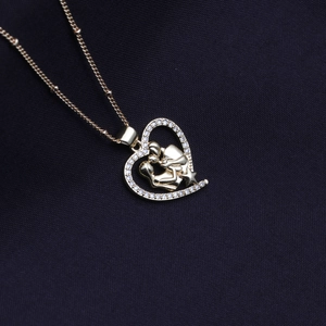 Golden heart necklace with family figure pendant and shimmering diamond-set edges