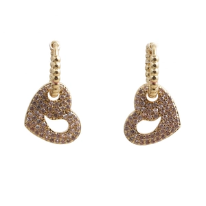 Close-up of gold heart earrings with shimmering cubic zirconia and hollow design