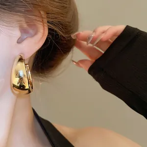 Minimalist gold-finished chunky water drop hoop earrings with a sleek mirror surface