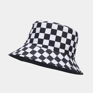 Detail of black and white checkerboard pattern on a reversible cotton bucket hat