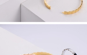 Macro detail of geometric serpent scale metal bracelet with hidden push clasp