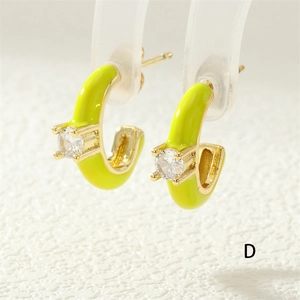 Detail of neon yellow C-shaped enamel earrings with sparkling cubic zirconia inlay