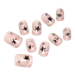 French cat-eye press-on nails in dusty pink with silver glitter and black star motifs