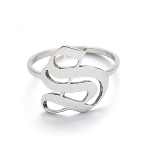 Macro shot of silver metal ring featuring an intricate hollow cursive letter S design