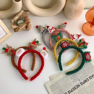 Close-up of assorted plush Christmas headbands with reindeer, snowman and Santa icons