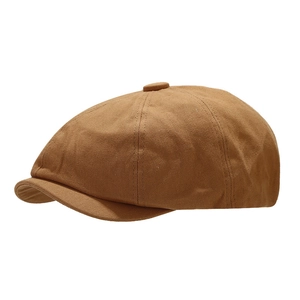 Vintage brown newsboy cap with diagonal twill texture and classic retro casual style