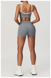 Detail of grey yoga set featuring high-waist shorts and contrast piping sports bra back