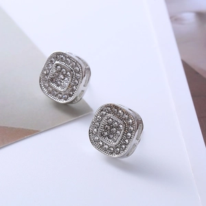 Close-up of geometric square stud earrings with shimmering pave-set crystal inlay