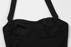 Detail view of black halter neck evening dress with structured bustier and sleek fabric