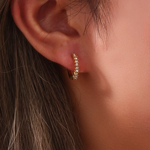 Close-up of minimalist 18K gold plated hoop earrings with micro-pave cubic zirconia