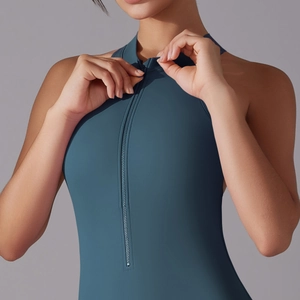 Detail view of the front zipper and stand collar on the deep teal fitness jumpsuit