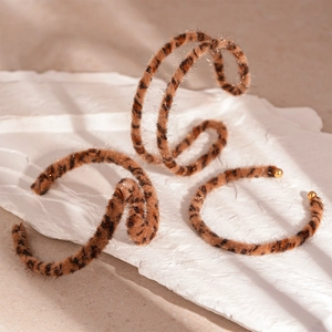 Three-piece leopard print faux fur cuff bracelets with golden metal bead ends set on stone