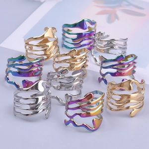 Detailed view of irregular wavy cut-out rings in gold, silver, and iridescent finishes
