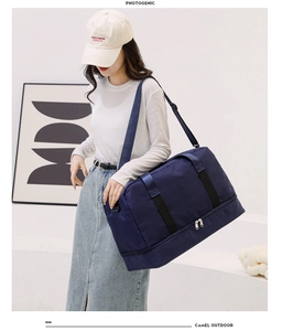 Detail view of the waterproof dark blue travel bag with separate bottom shoe compartment