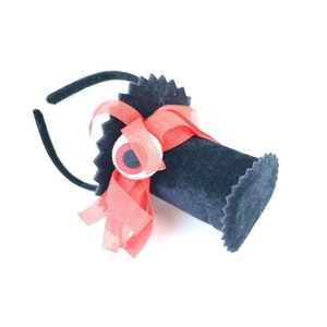 Detail of Halloween headband with black felt top hat, red mesh bow, and spooky eyeball decor