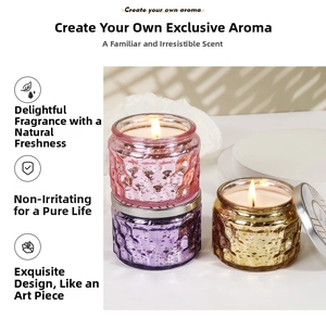 Three-piece embossed glass scented candle set with metallic lids and warm flickering flames