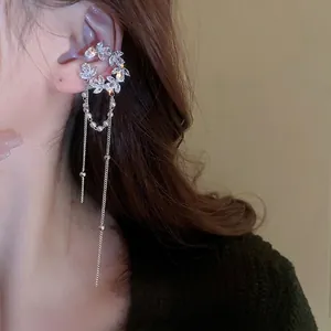 Elegant silver ear cuff with crescent zircon stones and pearl tassels shown on ear