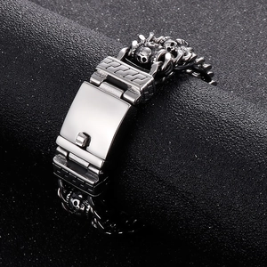 Detailed view of silver skull bracelet with engraved links and square metal clasp