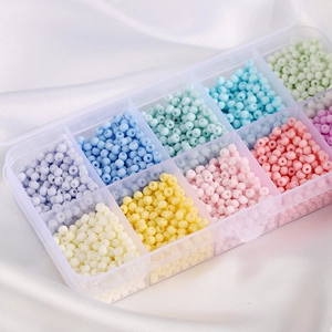 Macro view of macaron glass seed bead set in a clear plastic organizer box