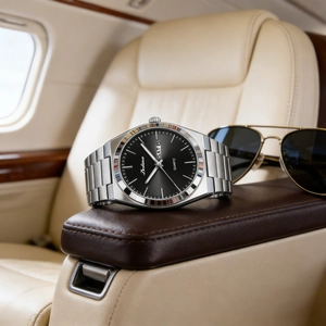 Macro shot of a silver steel men's watch with double calendar on a luxury leather seat